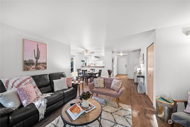 living room with wood-type flooring and ceiling fan