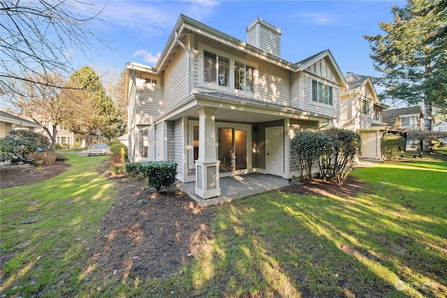 rear view of house with a yard and a patio area