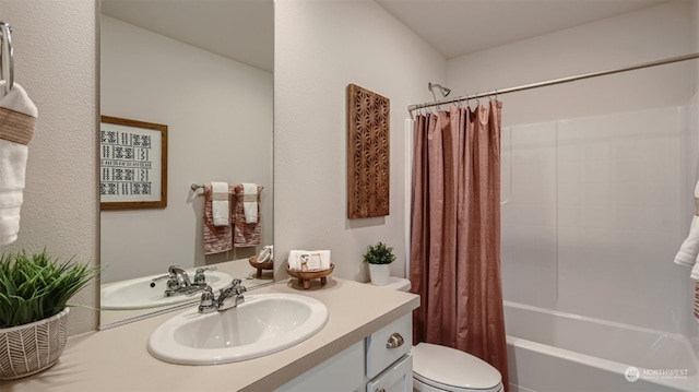 full bathroom with vanity, shower / bath combination with curtain, and toilet