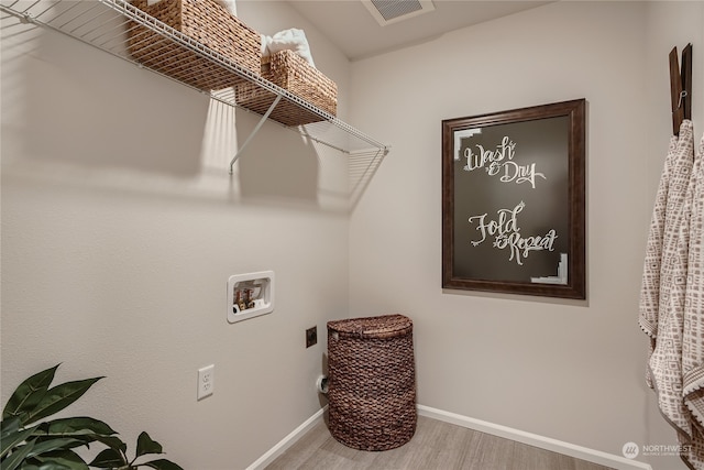 laundry area with hookup for a washing machine, wood-type flooring, and hookup for an electric dryer