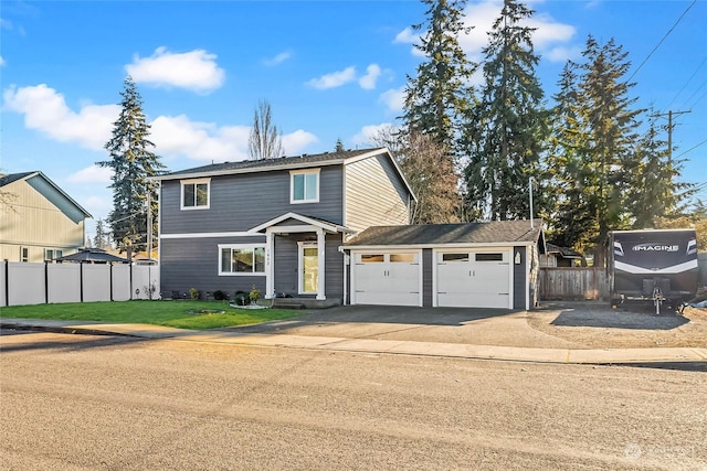 front of property with a garage and a front lawn