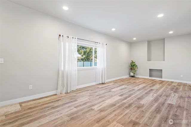 unfurnished living room featuring light hardwood / wood-style floors