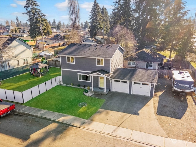 front facade featuring a garage, a gazebo, and a front yard