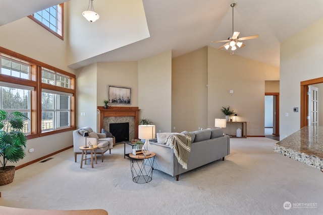 living room featuring ceiling fan, light colored carpet, and a high ceiling