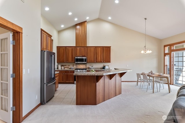 kitchen featuring a center island with sink, appliances with stainless steel finishes, a kitchen breakfast bar, pendant lighting, and light colored carpet