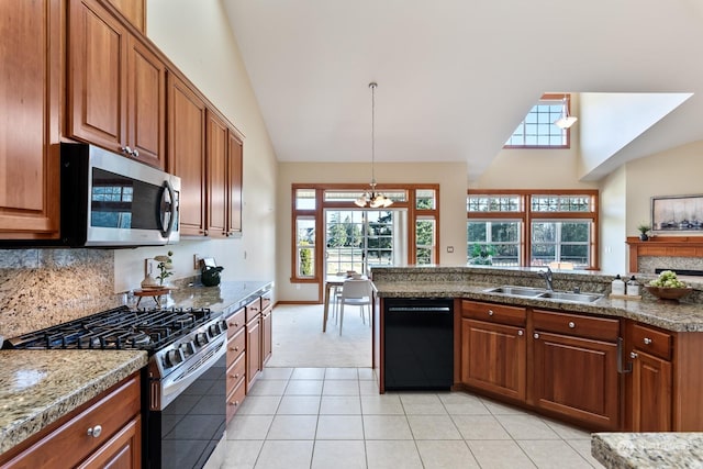 kitchen with sink, light tile patterned floors, hanging light fixtures, stainless steel appliances, and tasteful backsplash