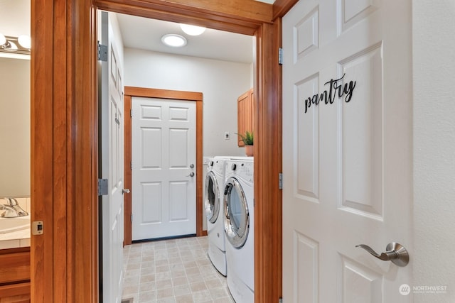 washroom with cabinets and separate washer and dryer