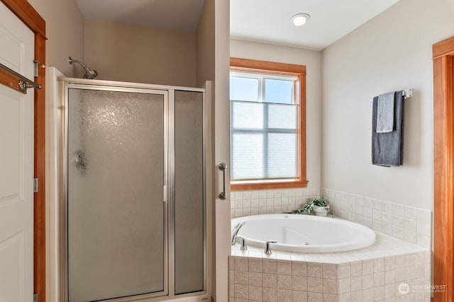 bathroom featuring separate shower and tub