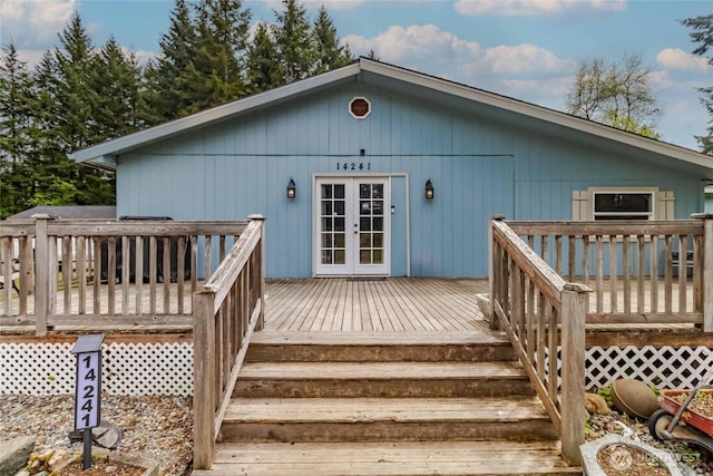 rear view of house featuring french doors and a wooden deck