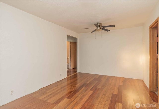 spare room featuring a ceiling fan and wood finished floors