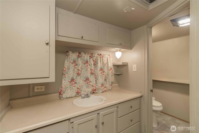 bathroom featuring vanity and toilet