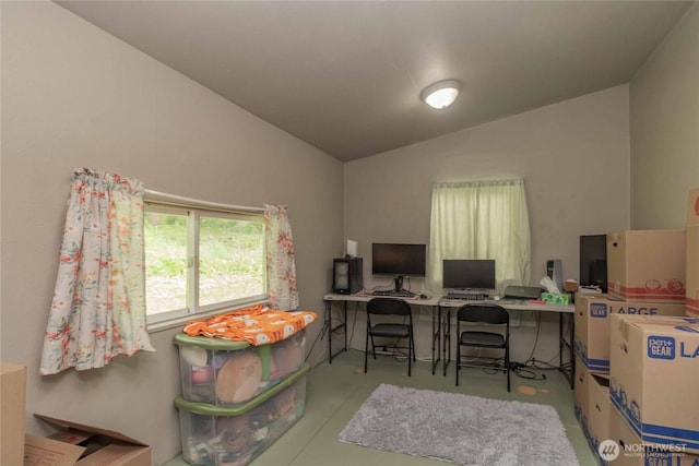 office space featuring lofted ceiling and concrete flooring