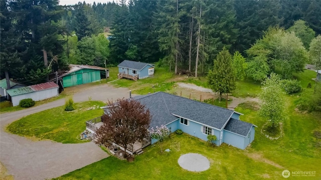 view from above of property with a heavily wooded area