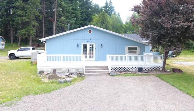 14241 State Route 507 SE, Yelm, WA 98597 - view of front of house featuring a front yard, french doors, and a wooden deck