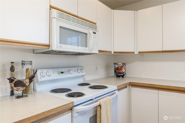 kitchen featuring white cabinetry and white appliances