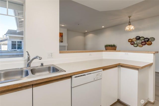 kitchen featuring white cabinetry, sink, decorative light fixtures, and dishwasher