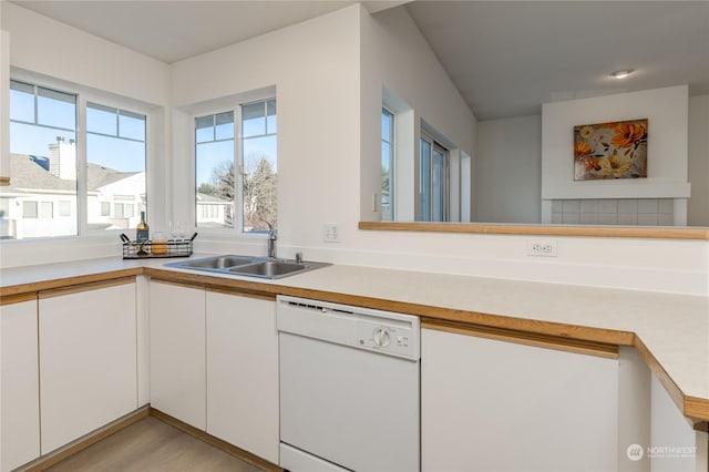 kitchen featuring white cabinetry, sink, and dishwasher