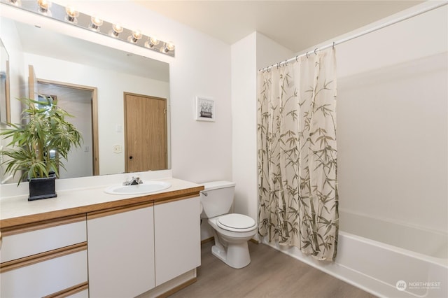 full bathroom featuring vanity, hardwood / wood-style floors, shower / bathtub combination with curtain, and toilet