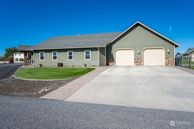 single story home featuring a garage and a front yard