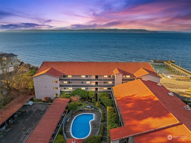 aerial view at dusk with a water view