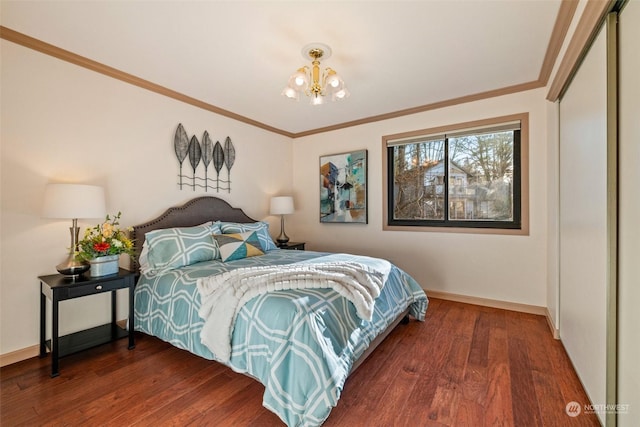 bedroom featuring an inviting chandelier, ornamental molding, and dark hardwood / wood-style floors