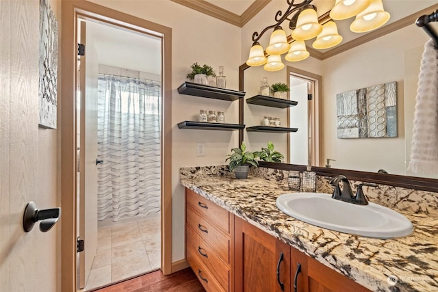 bathroom with hardwood / wood-style flooring, crown molding, and vanity