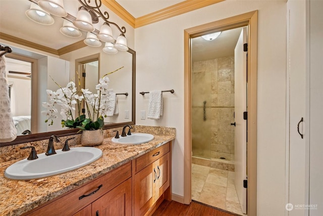 bathroom featuring crown molding, tiled shower, hardwood / wood-style floors, and vanity