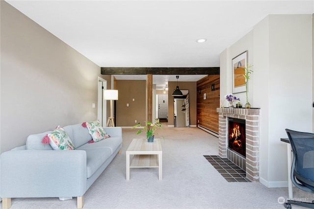 living room with baseboard heating, beam ceiling, wooden walls, carpet, and a fireplace