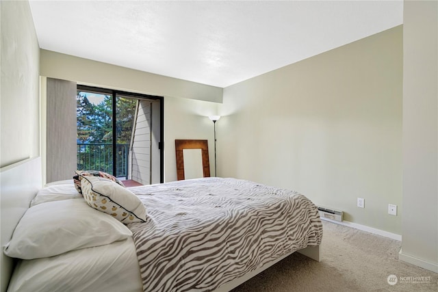 carpeted bedroom featuring a baseboard heating unit and access to outside