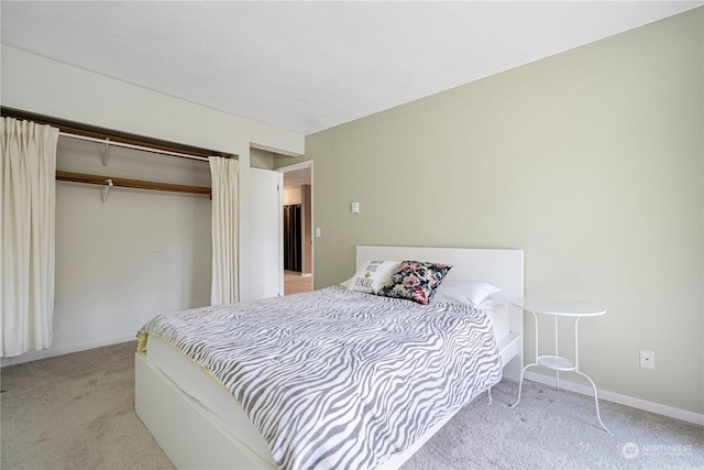 bedroom with a closet and light carpet