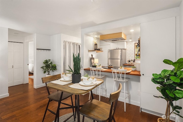 dining area featuring dark wood-type flooring