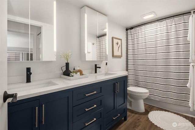 bathroom featuring vanity, hardwood / wood-style floors, toilet, and a shower with shower curtain