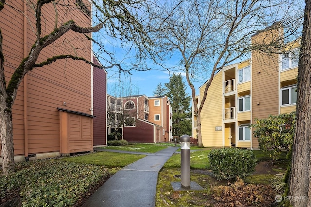 view of property's community with a lawn