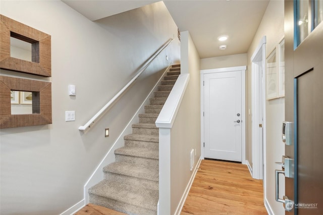 stairway featuring hardwood / wood-style flooring