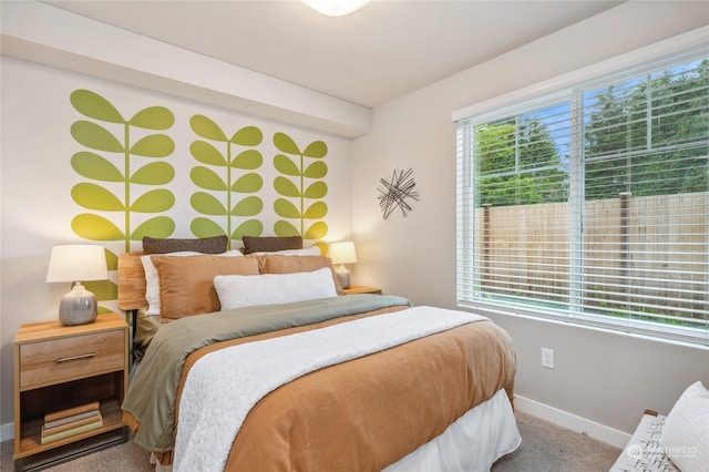 carpeted bedroom featuring multiple windows