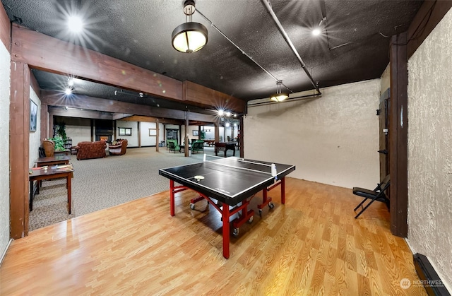 recreation room with hardwood / wood-style floors