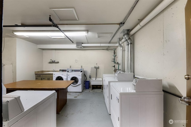 clothes washing area with washer and clothes dryer