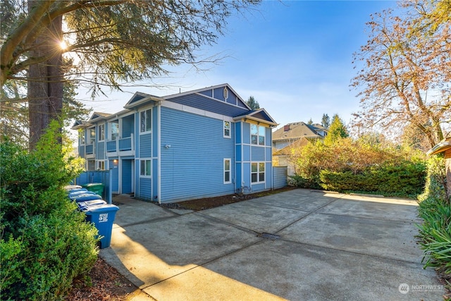 view of side of property featuring a patio area and a balcony