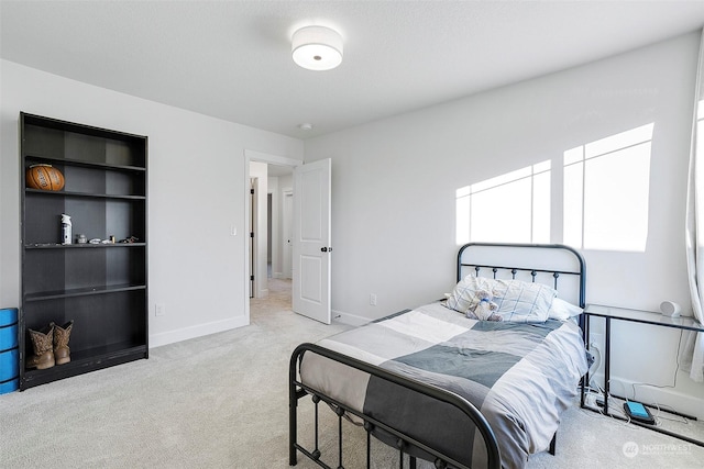 bedroom featuring light carpet