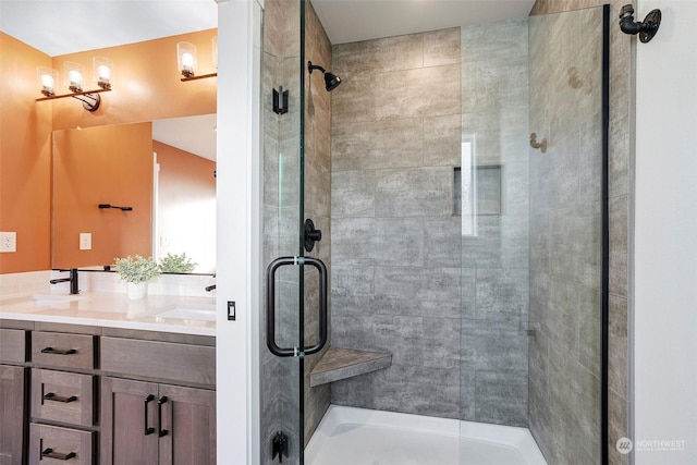 bathroom with vanity and a shower with door