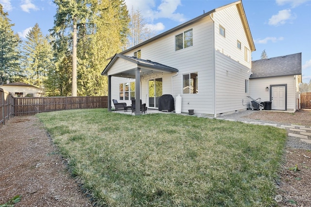 back of property with a yard and a patio