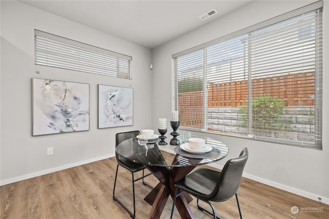 dining space with light hardwood / wood-style floors