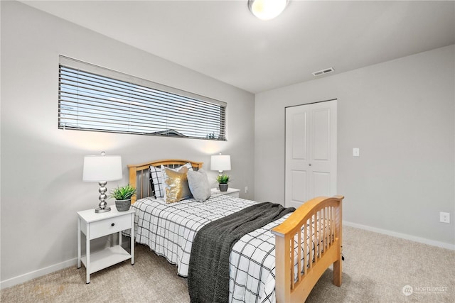 carpeted bedroom featuring a closet