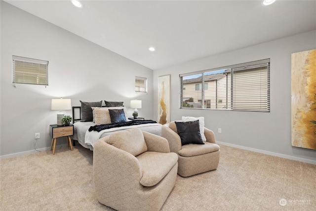 bedroom with vaulted ceiling and light carpet