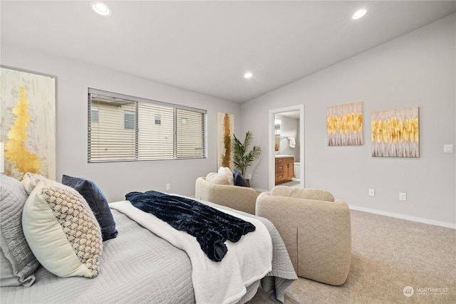 bedroom featuring lofted ceiling, connected bathroom, and carpet