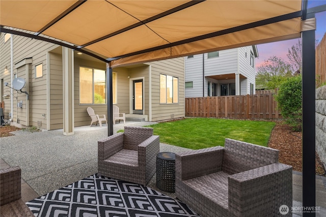 patio terrace at dusk with fence, an outdoor hangout area, and a lawn
