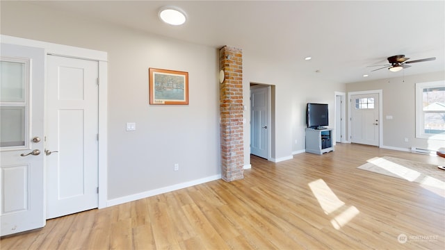 unfurnished living room with light hardwood / wood-style flooring, ceiling fan, and baseboard heating