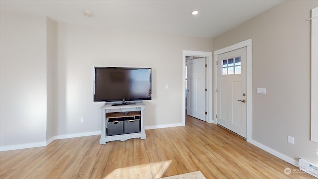 foyer entrance featuring light hardwood / wood-style floors and baseboard heating