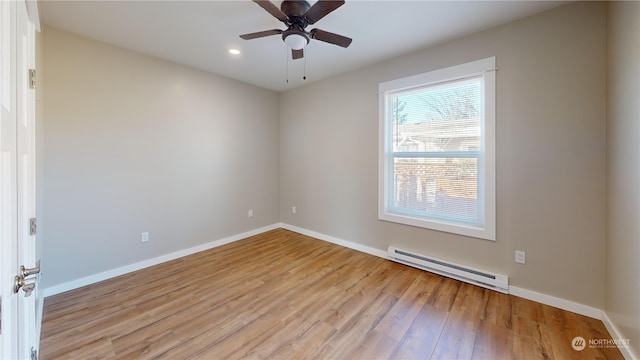 empty room with baseboard heating, ceiling fan, and light hardwood / wood-style flooring