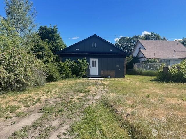 rear view of house featuring board and batten siding